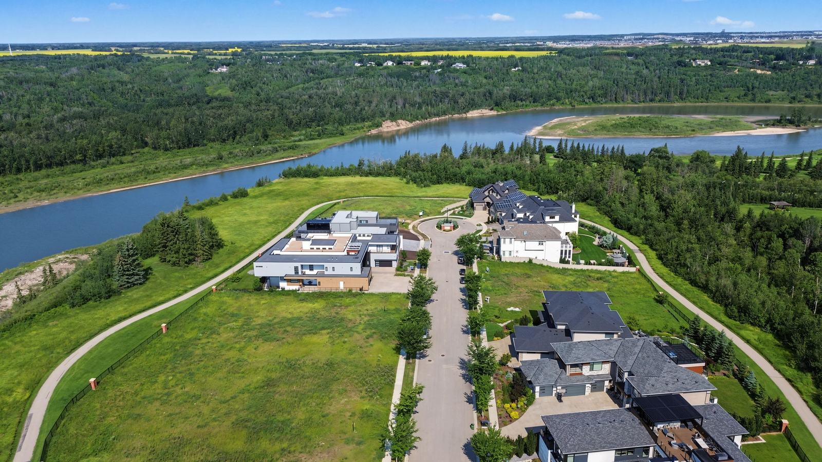 A contemporary estate home on the valley rim with the river directly behind it.