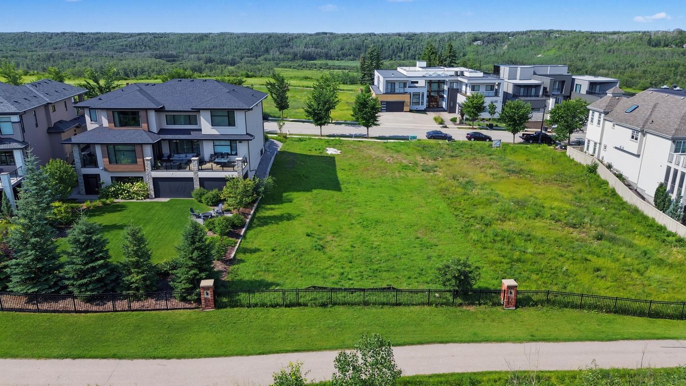 Keswick Boulevard in front of Lot 6, a paved street with completed estate homes and young trees.